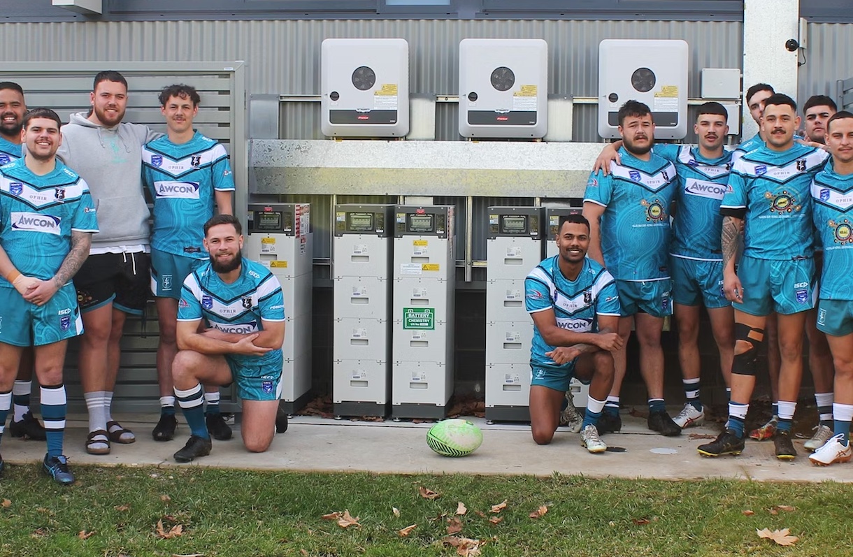 sports team in front of battery storage system